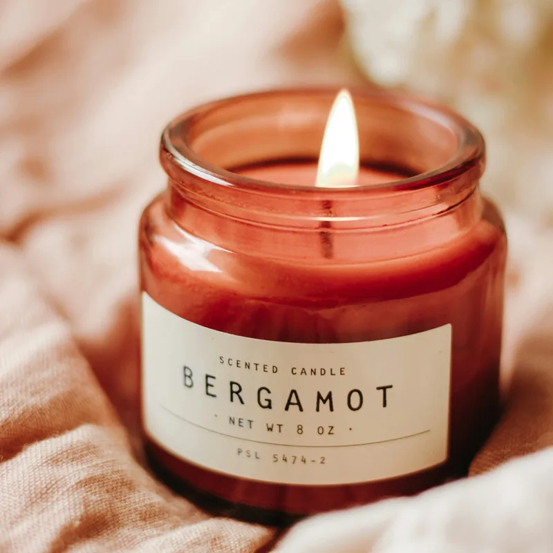 Original photo: a red glass candle jar labelled Bergamot